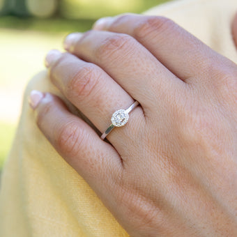 10ct White Gold 1/6 Carat Diamond Ring with Oval Centre and Halo